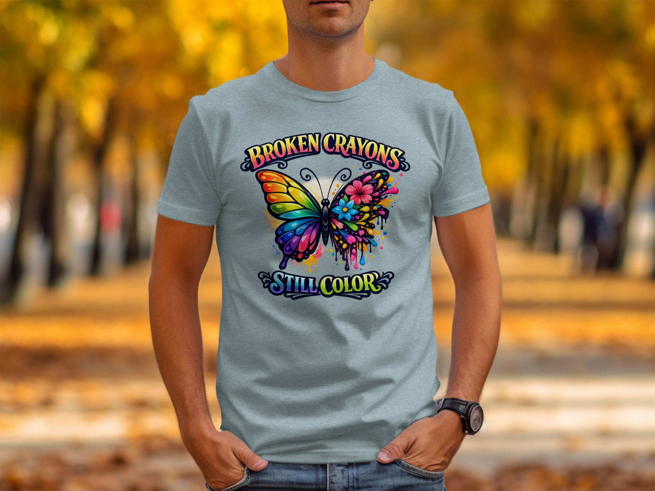 Grey t-shirt with "BROKEN CRAYONS STILL COLOR" and colorful butterfly graphic.