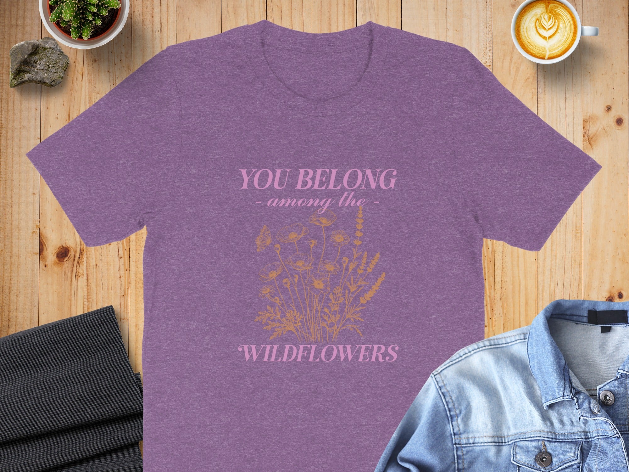 Purple t-shirt with "YOU BELONG - among the - WILDFLOWERS" text and floral graphic.
