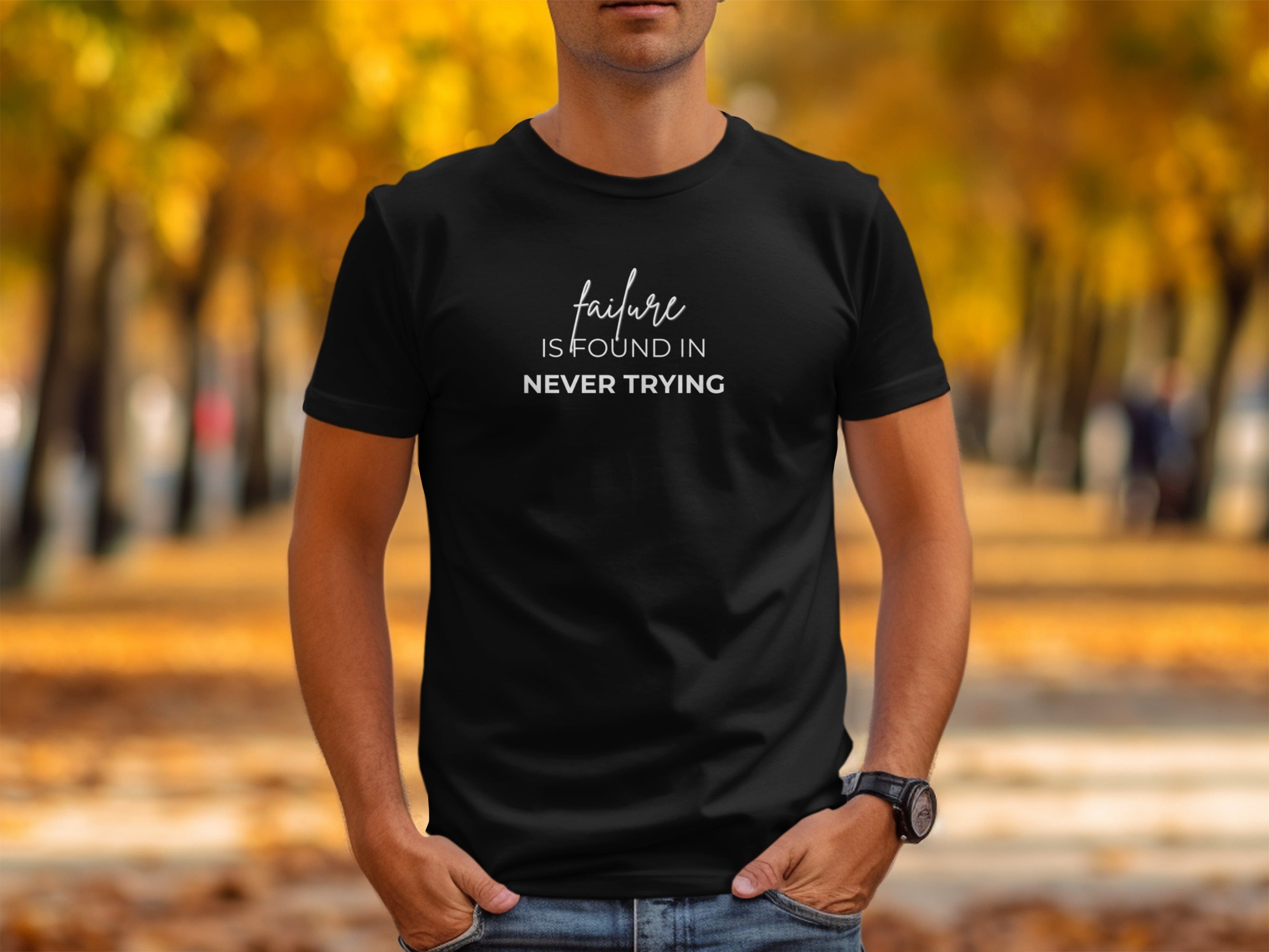 Black t-shirt with white text reading "failure IS FOUND IN NEVER TRYING."