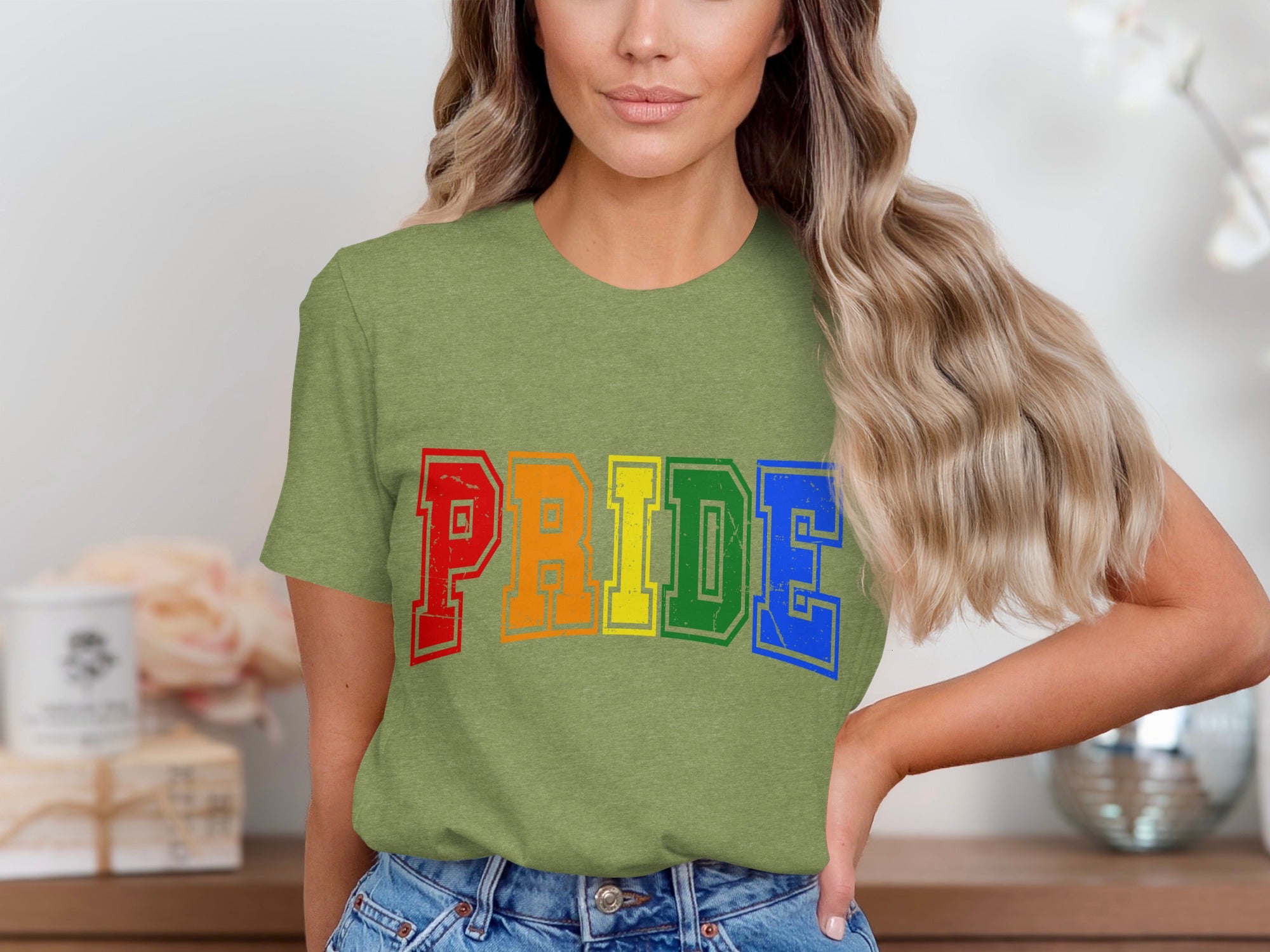 Green t-shirt with "PRIDE" in rainbow-colored block letters.