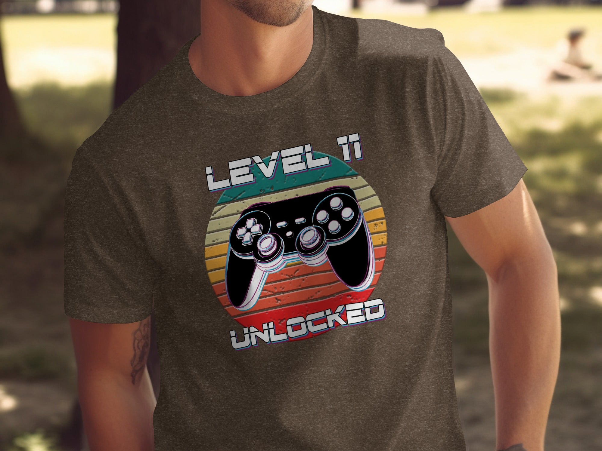 T-shirt with "Level 11 Unlocked" text and a retro video game controller graphic.