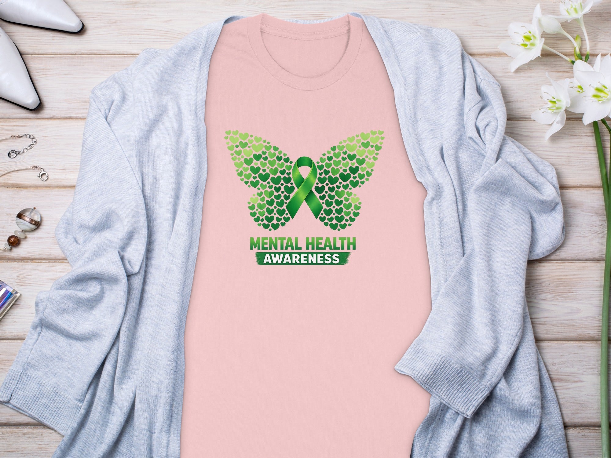 Pink t-shirt with green butterfly design and "Mental Health Awareness" text.