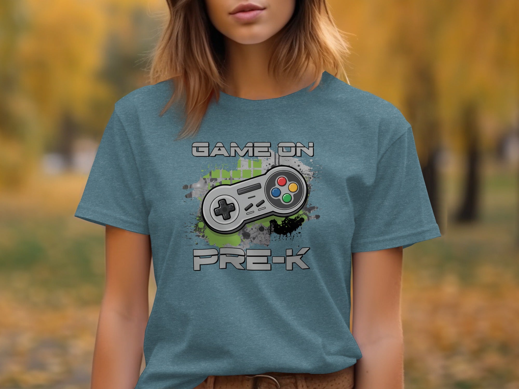 Vintage style video game controller with text "GAME ON PRE-K" on a teal t-shirt.