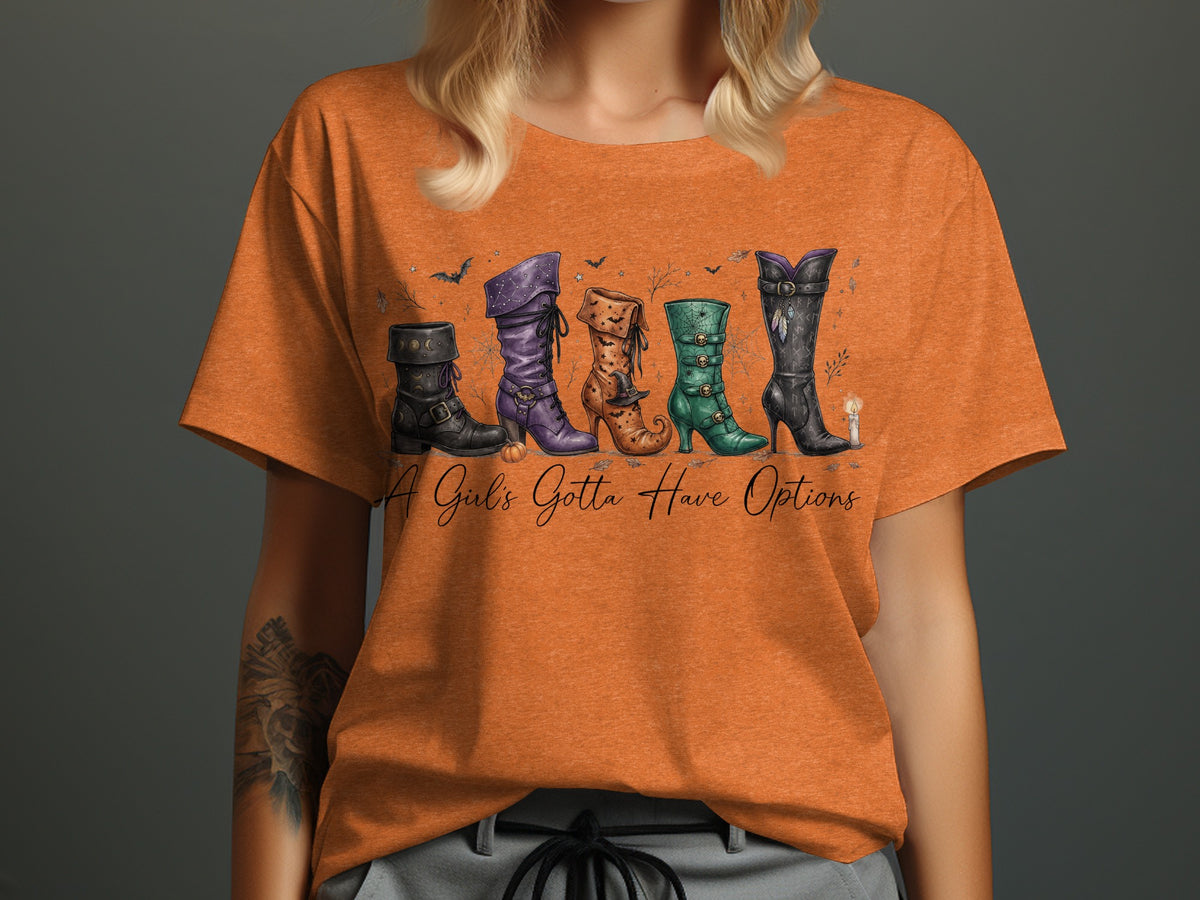 Orange t-shirt with five witch boots and text "A Girl's Gotta Have Options".