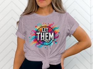 Light purple t-shirt with colorful, abstract design and "LET THEM" text.