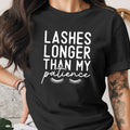 Black t-shirt with white text that reads "Lashes Longer Than My Patience".