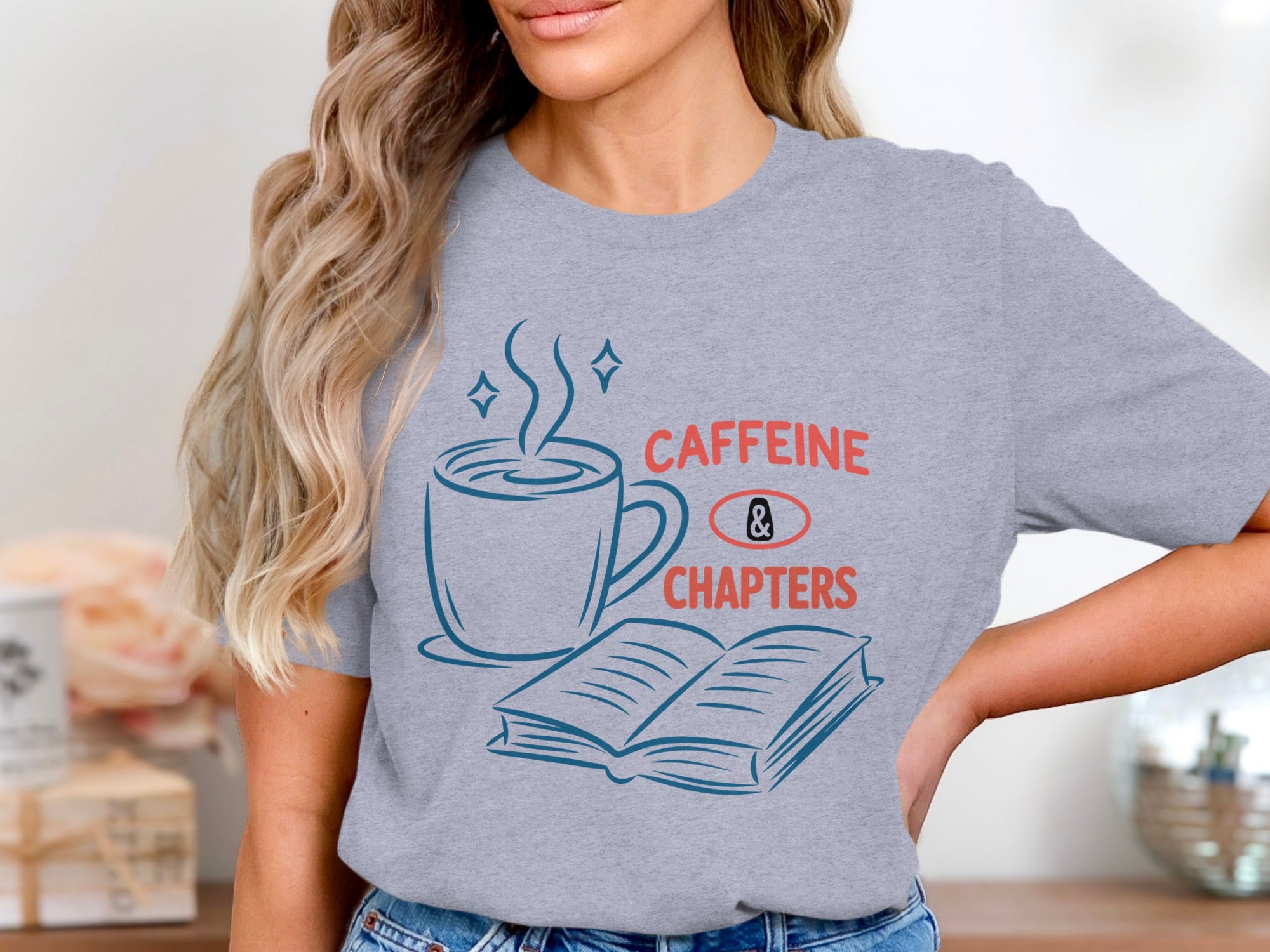 Gray t-shirt with "CAFFEINE & CHAPTERS" text, a coffee cup, and an open book.