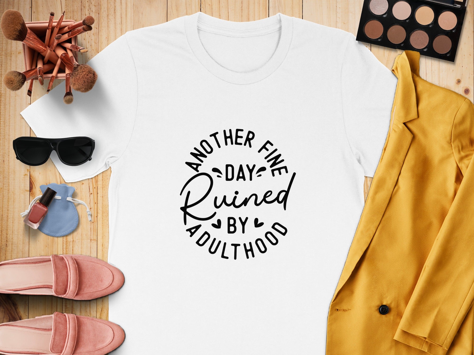 White t-shirt with black text reading "Another Fine Day Ruined By Adulthood".