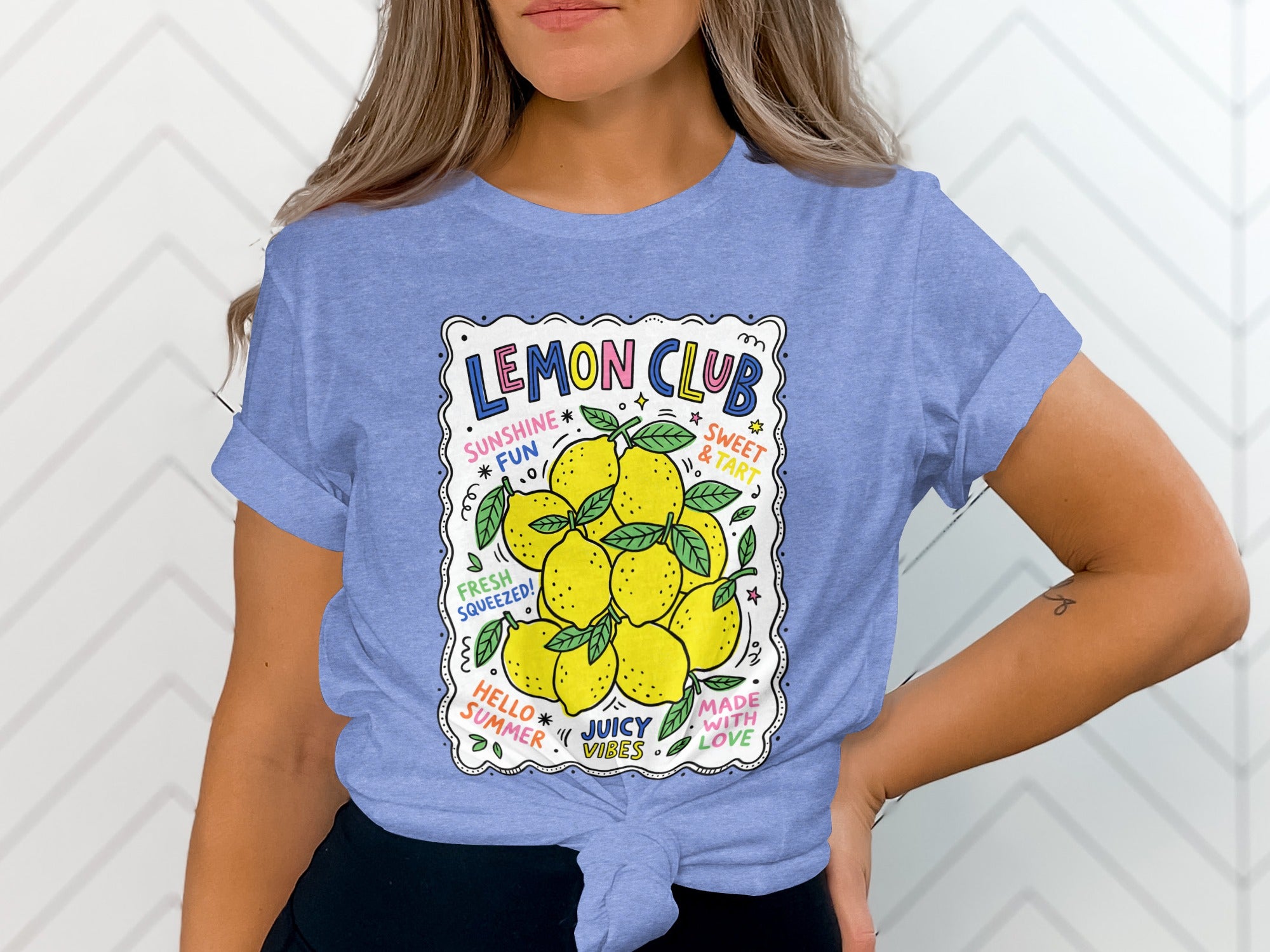Blue t-shirt with "Lemon Club" and lemons graphic, featuring text "Sunshine Fun", "Sweet & Tart", "Fresh Squeezed", and "Juicy Vibes".