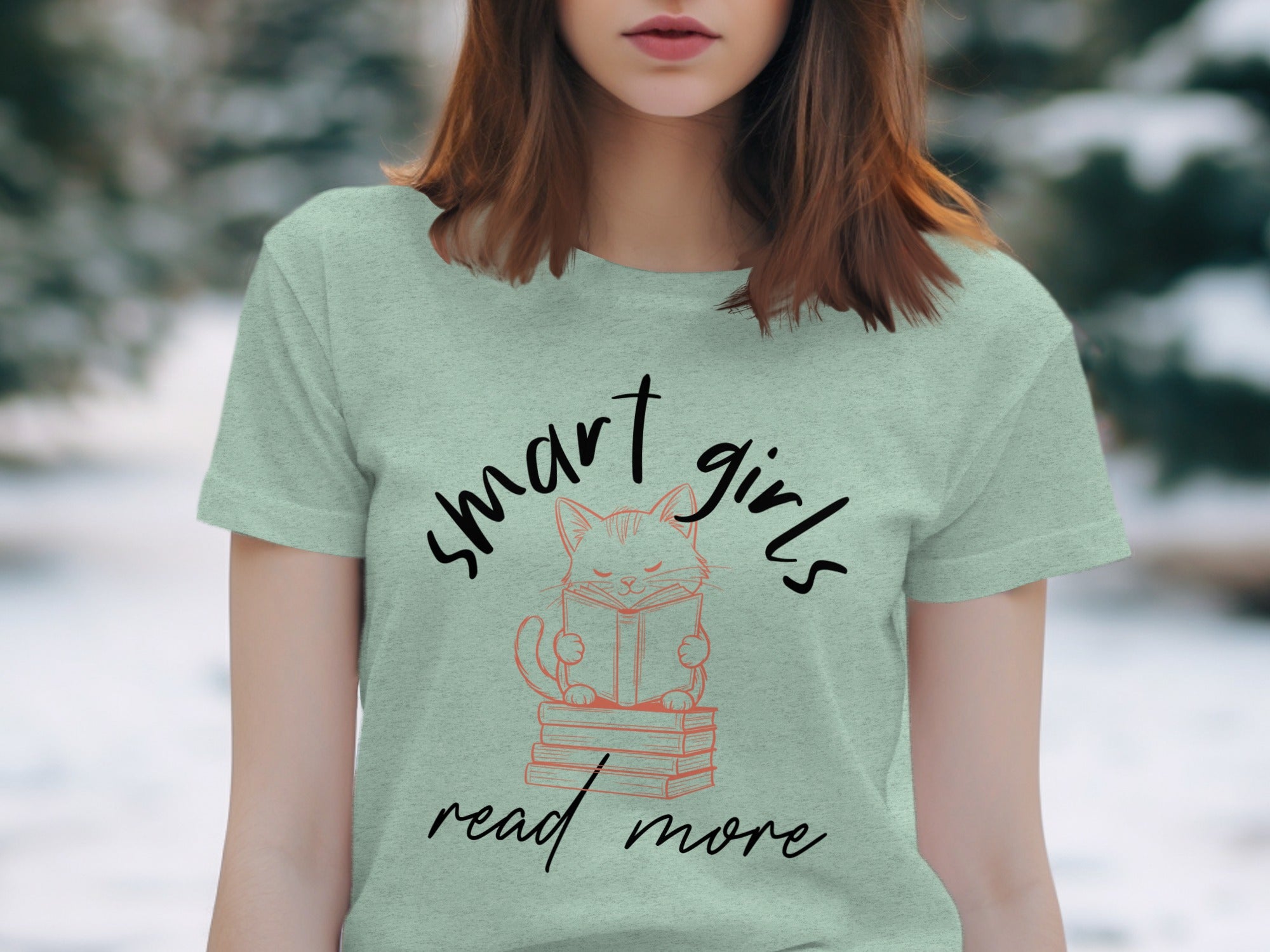 Light green t-shirt with "smart girls read more" and a cat reading on books graphic.