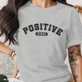 Grey t-shirt with "POSITIVE VIBES" text in distressed black lettering.