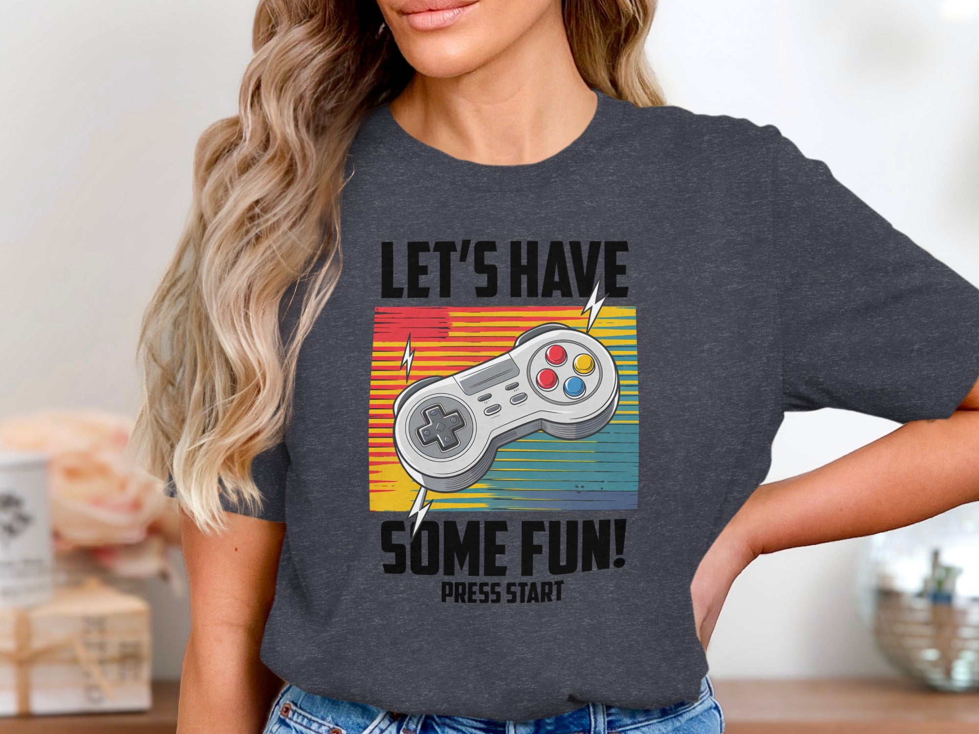 Gray t-shirt with "LET'S HAVE SOME FUN! PRESS START" and a video game controller.