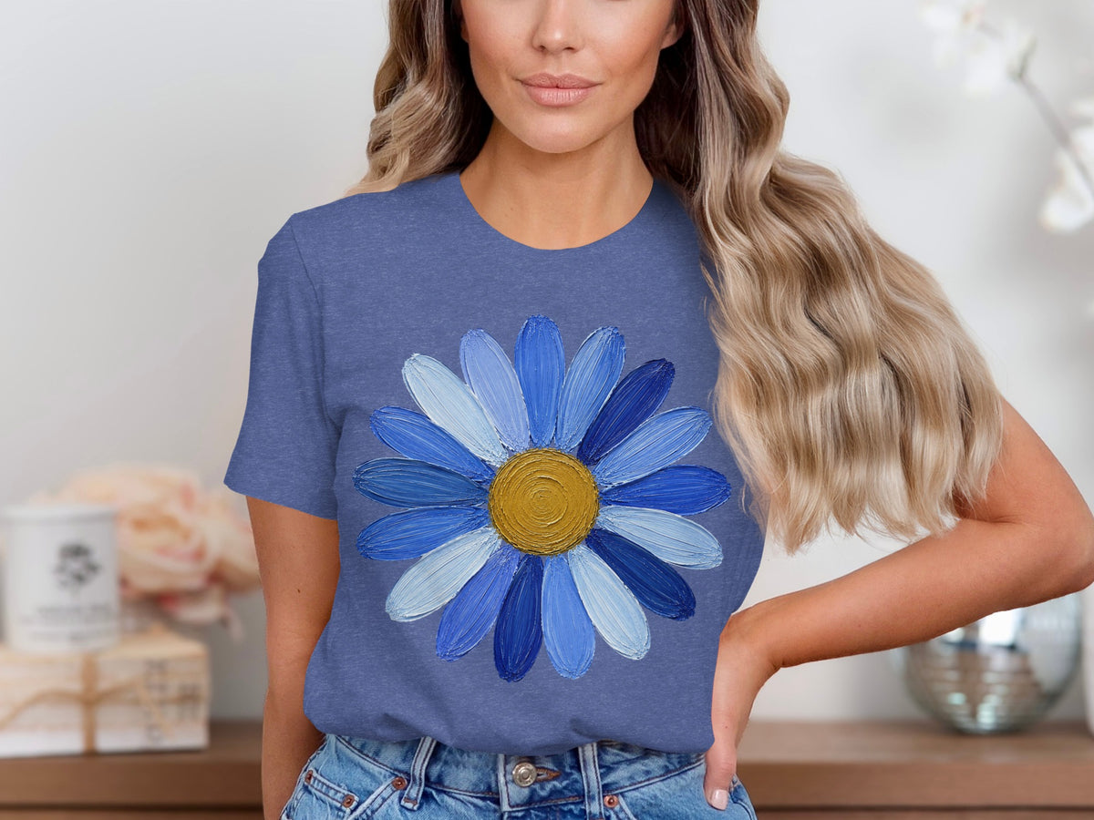 Blue t-shirt with textured blue daisy graphic and gold center.