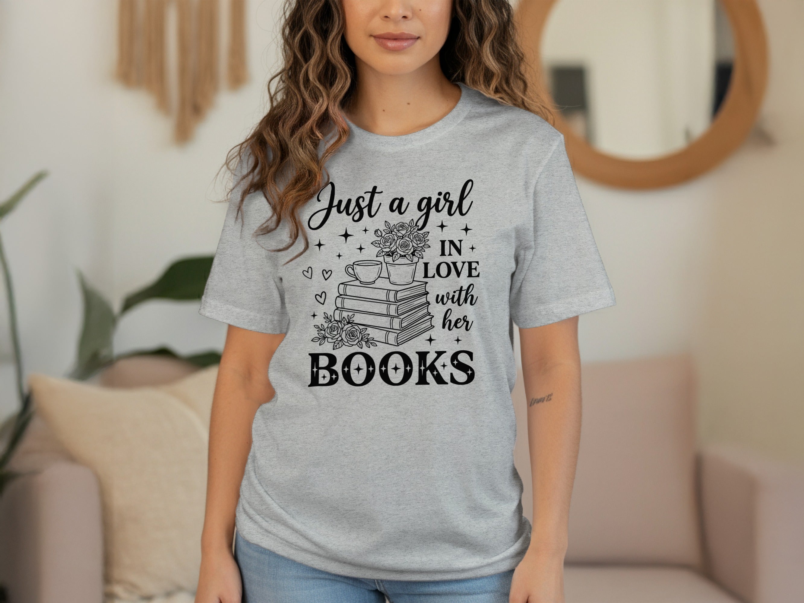 Grey t-shirt with black text and graphic "Just a girl in love with her books".