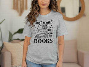 Grey t-shirt with black text and graphic "Just a girl in love with her books".