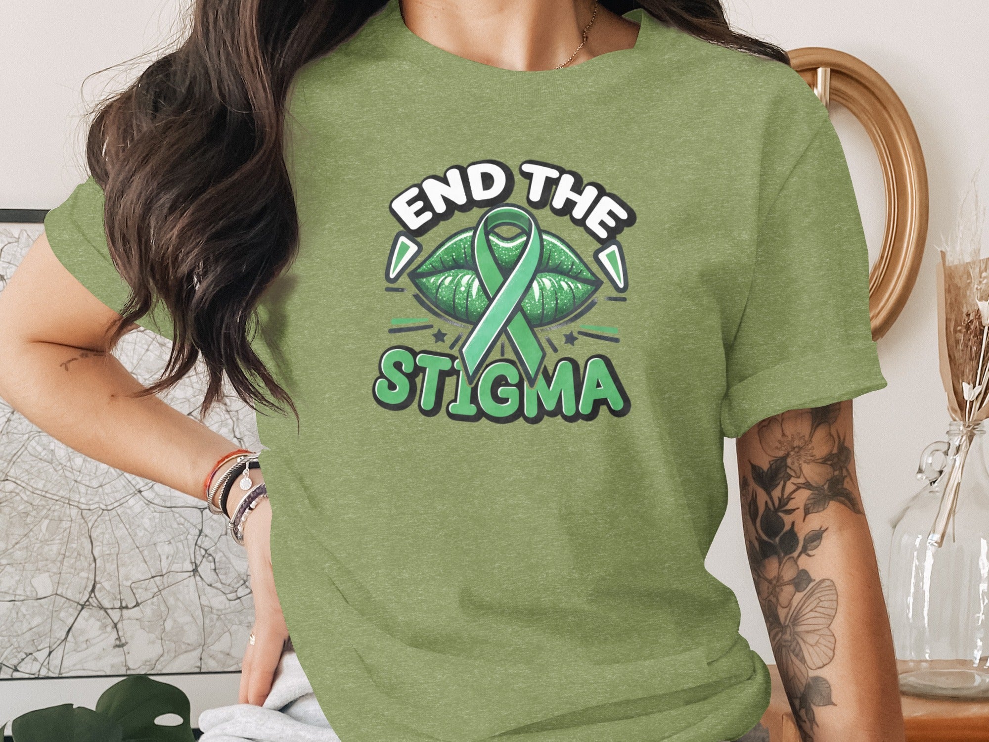 Green t-shirt with "End The Stigma" text and green ribbon over lips graphic.