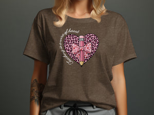 Brown t-shirt with a heart graphic that says "Teaching is a work of heart."