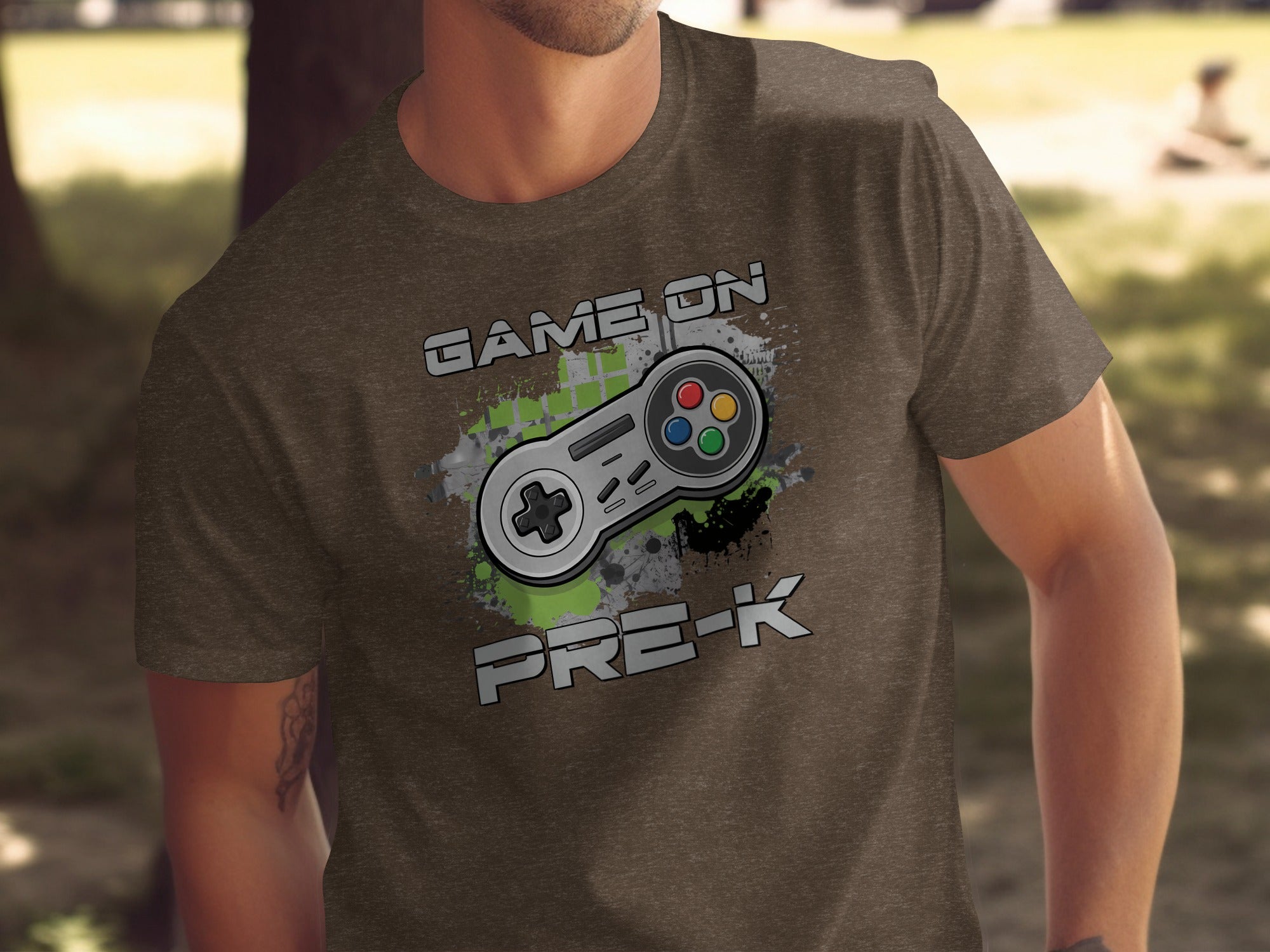 Brown t-shirt with "GAME ON PRE-K" text and a video game controller.