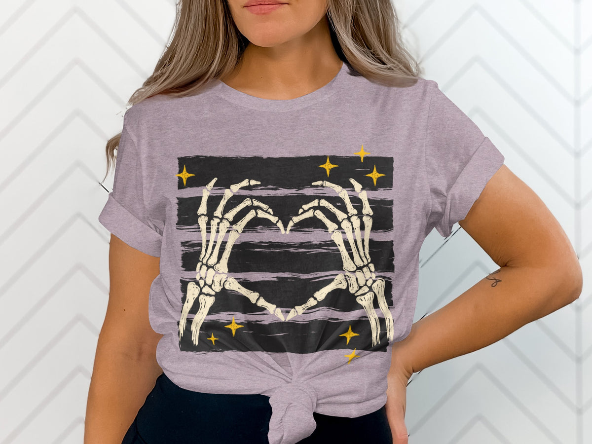 Skeleton hands form a heart over a striped background with yellow stars.
