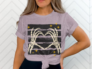 Skeleton hands form a heart over a striped background with yellow stars.