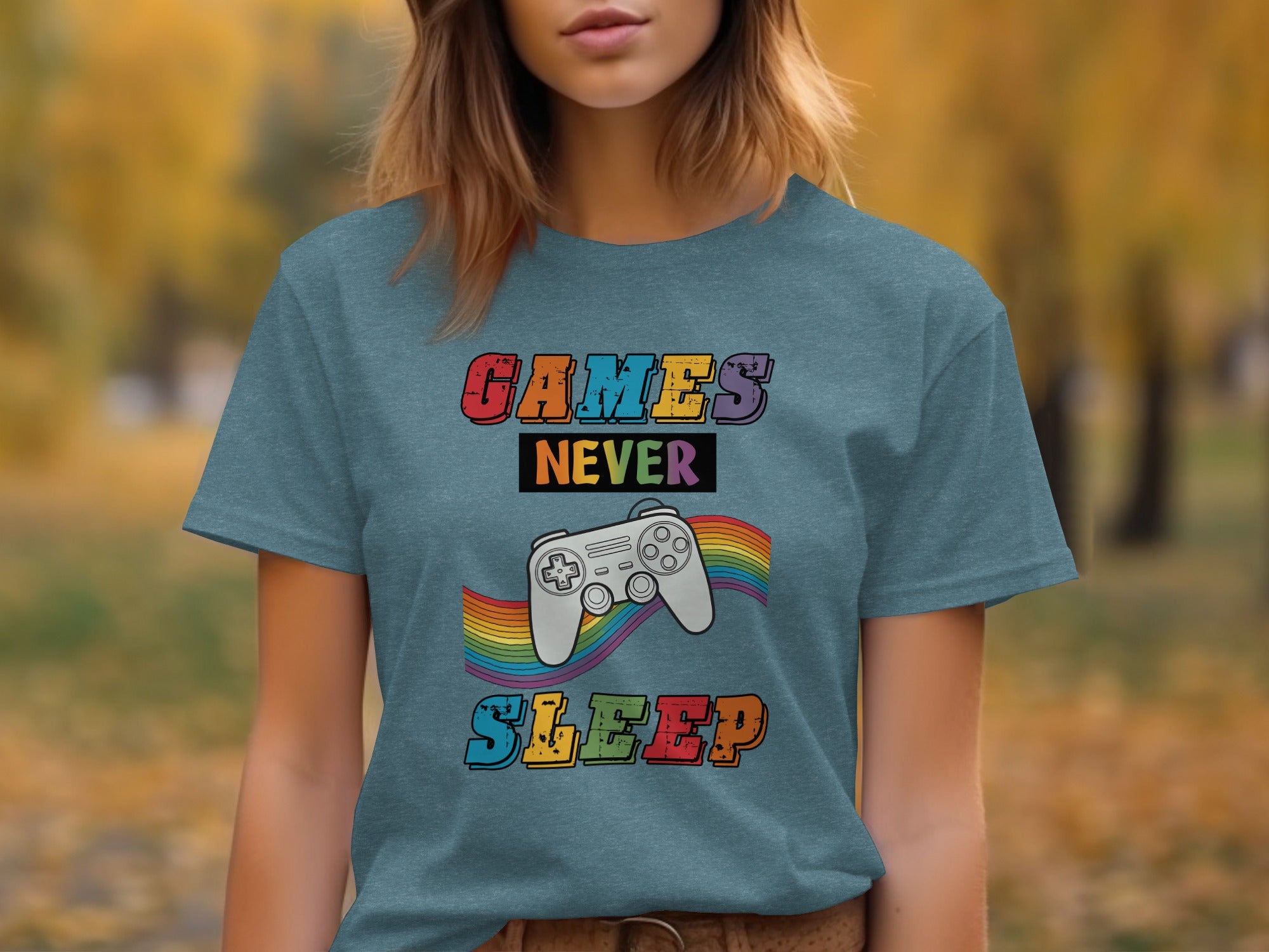 Teal t-shirt with "GAMES NEVER SLEEP" text and a gray video game controller.