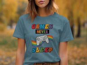 Teal t-shirt with "GAMES NEVER SLEEP" text and a gray video game controller.