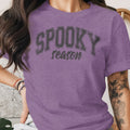 Purple t-shirt with "SPOOKY season" text in gray block letters.