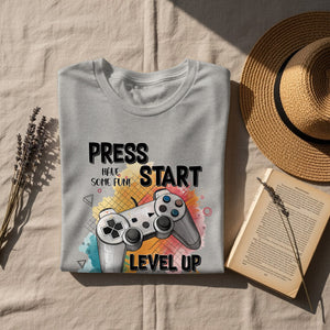 Gray t-shirt with "Press Start Have Some Fun Level Up" and video game controller graphic.
