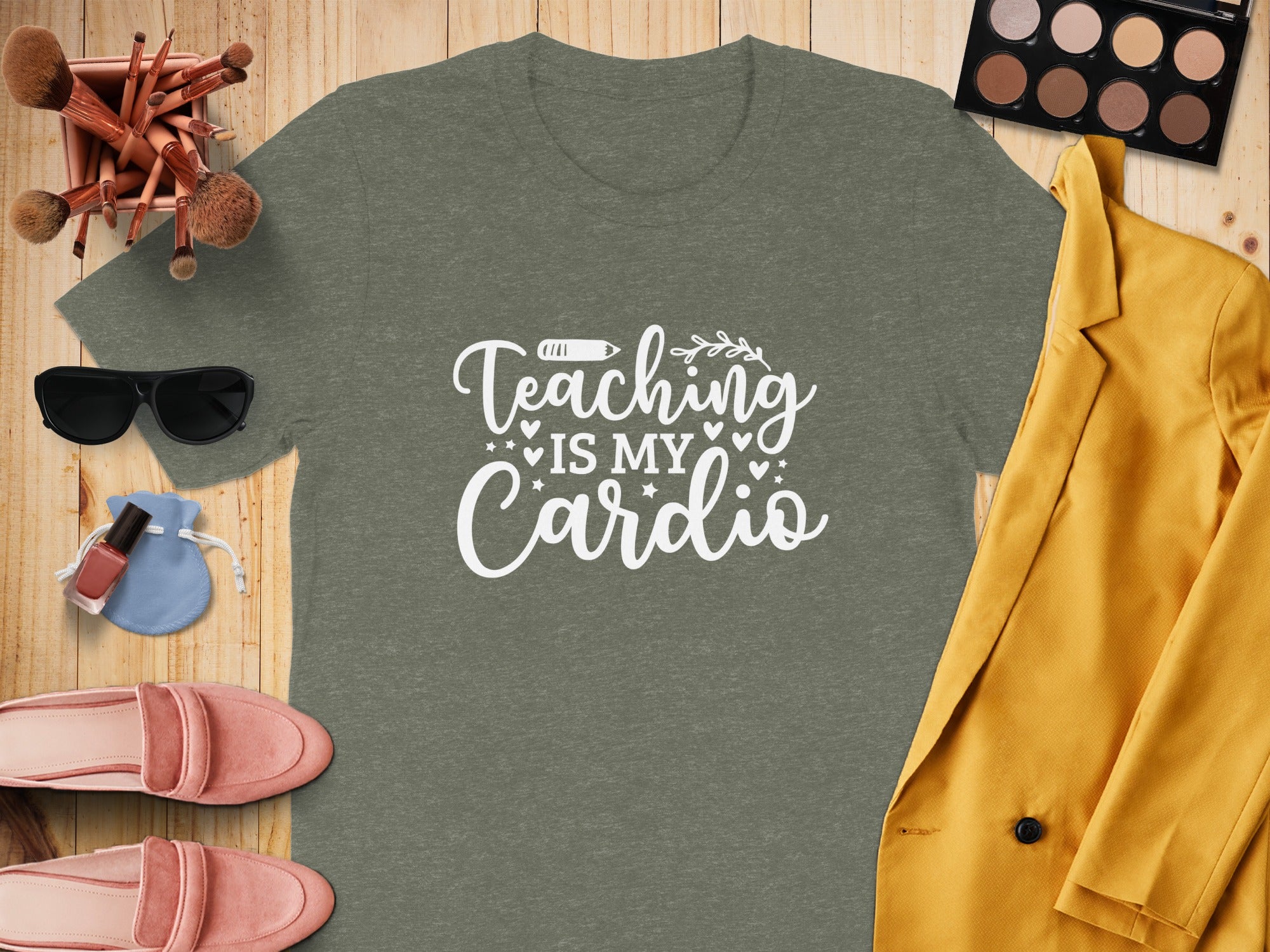Olive green t-shirt with white text "Teaching is My Cardio" surrounded by makeup.