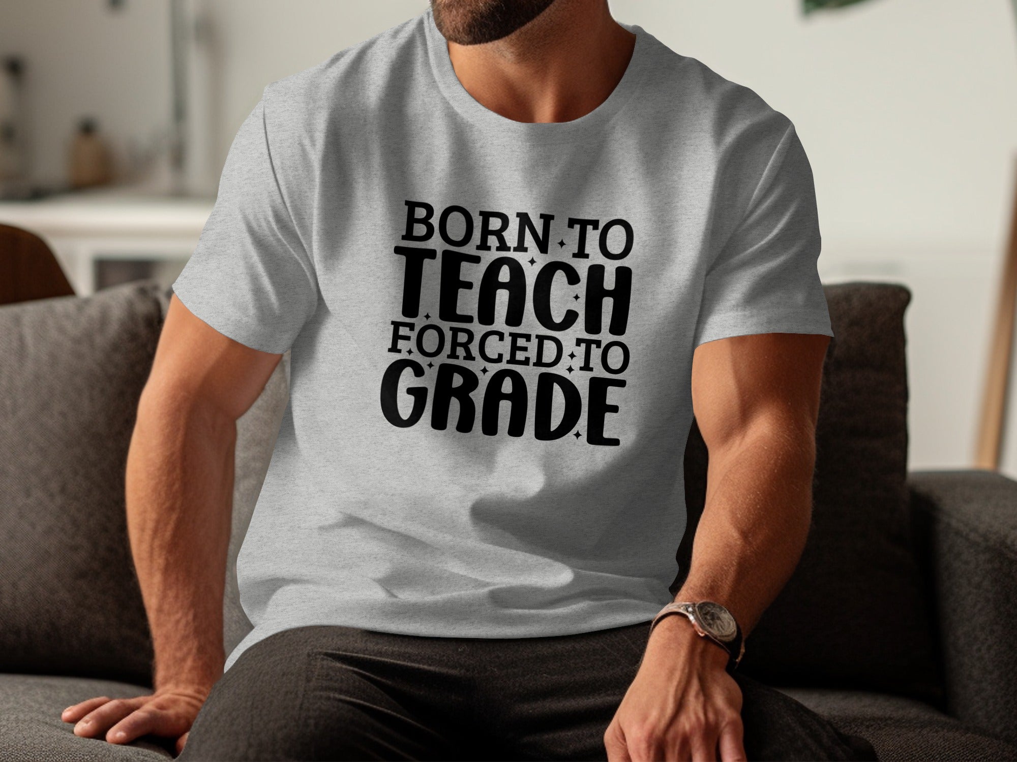 Gray t-shirt with black text "BORN TO TEACH FORCED TO GRADE".