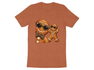 Two gingerbread cookies with sunglasses and bling on a rust-colored t-shirt.